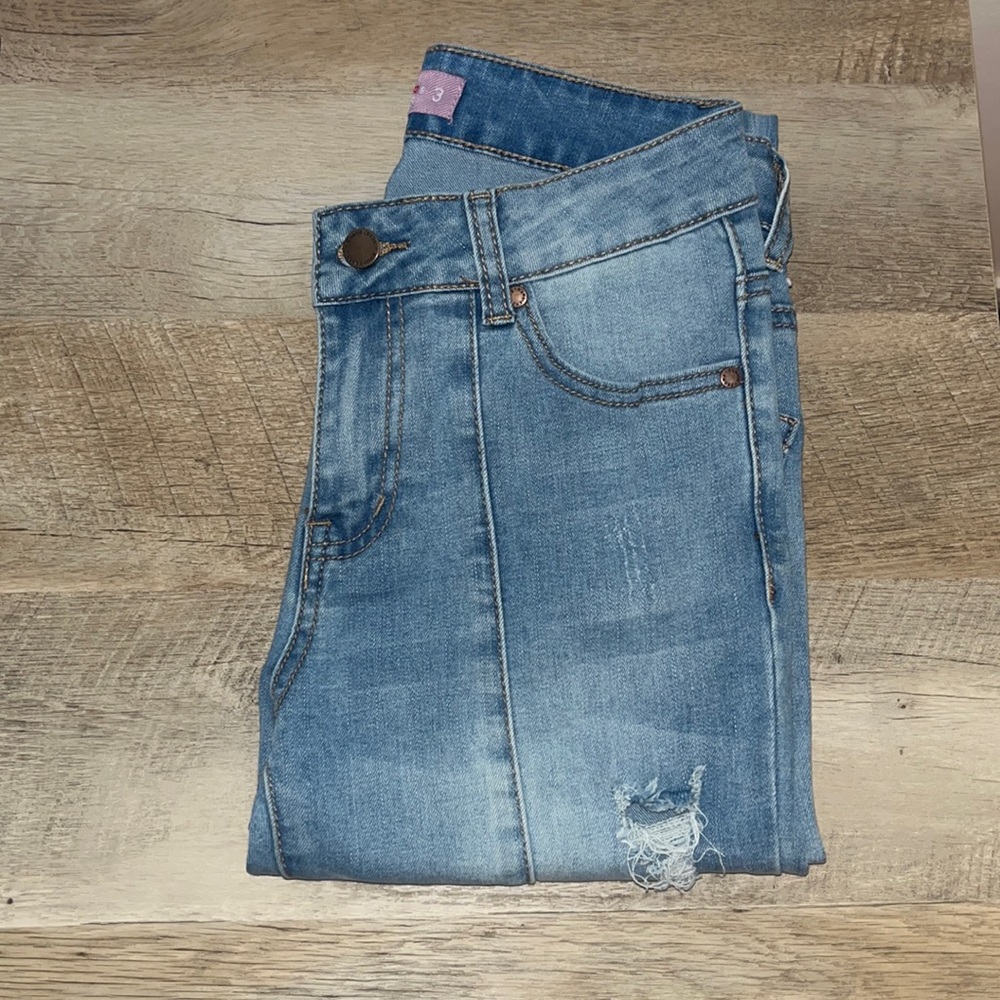 K’smore light wash ripped denim jeans with seam down the front.
